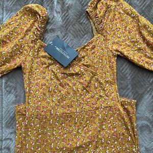 A mustard yellow midi bodycon dress